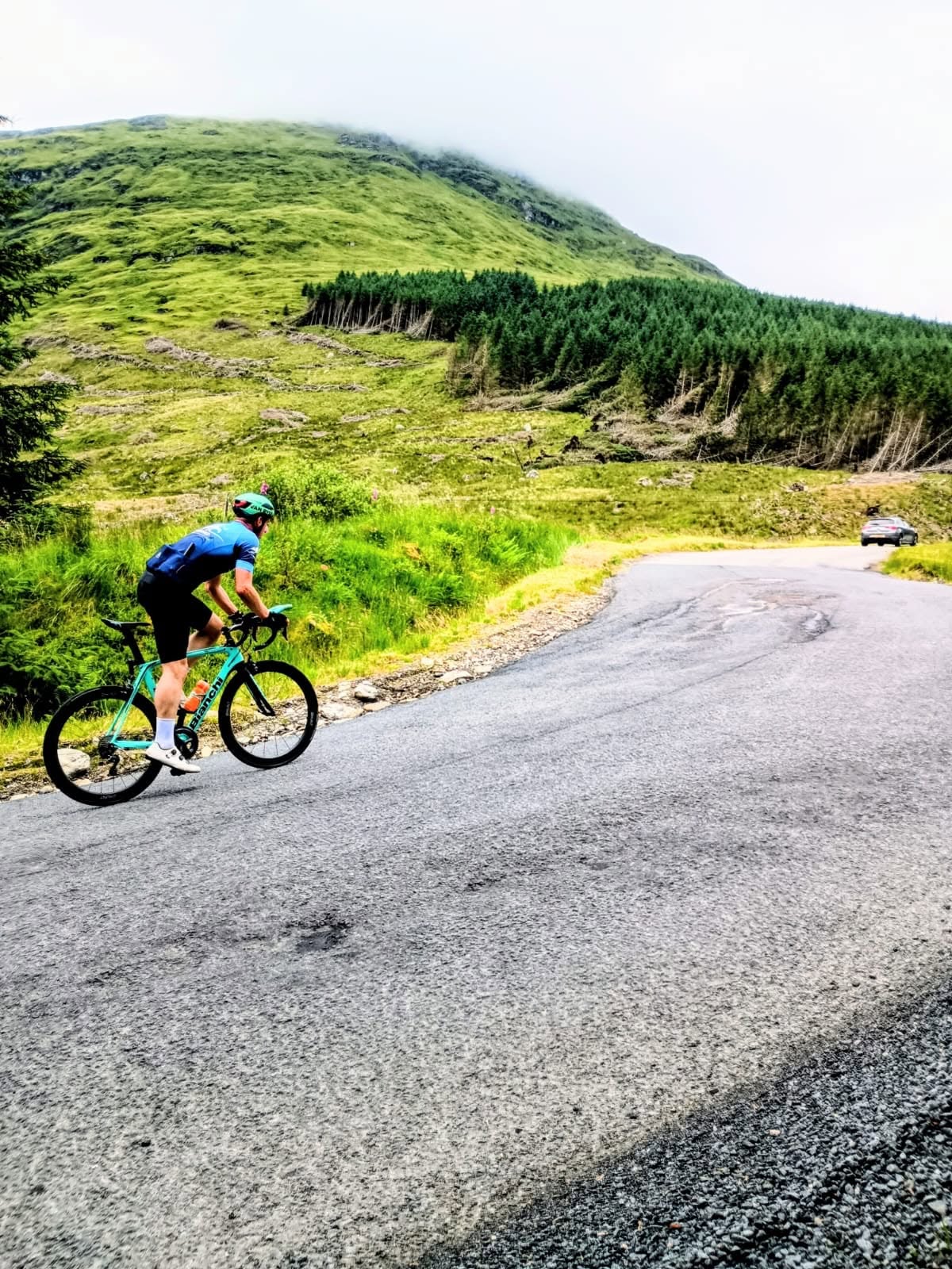 A Lomond cyclist climbing through the Scottish hills